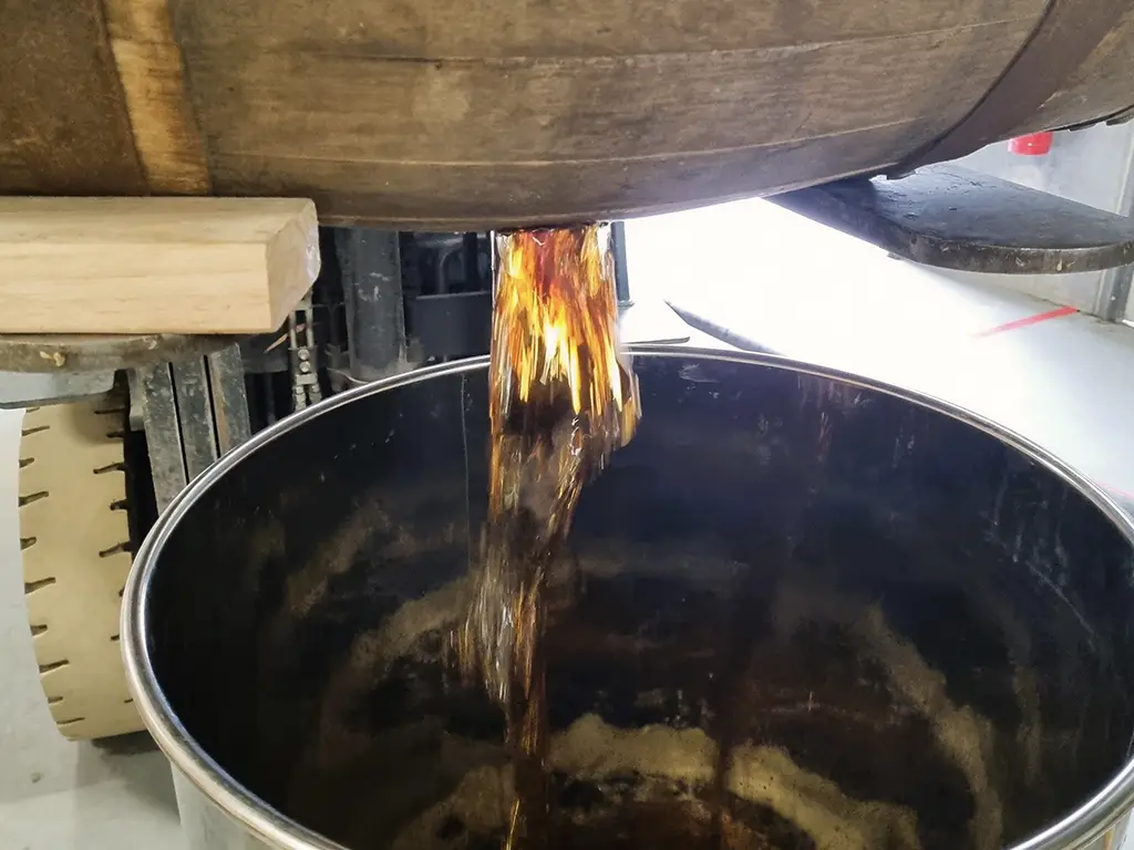 custom whisky pouring from a barrel at the white label distillery in tasmania