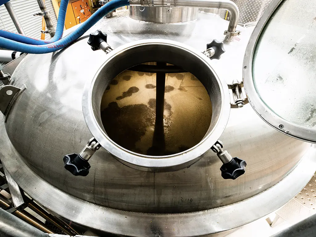 custom whisky fermenting inside the fermentation tank at the white label distillery in tasmania.