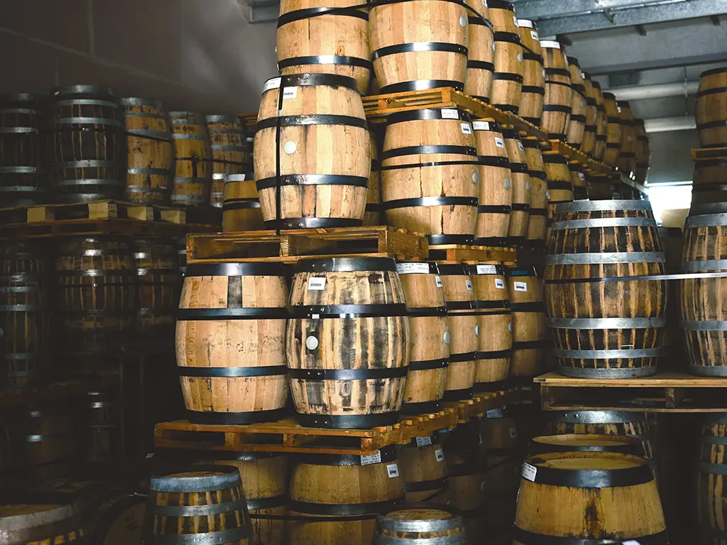 barrels of whisky aging at the white label distillery in tasmania