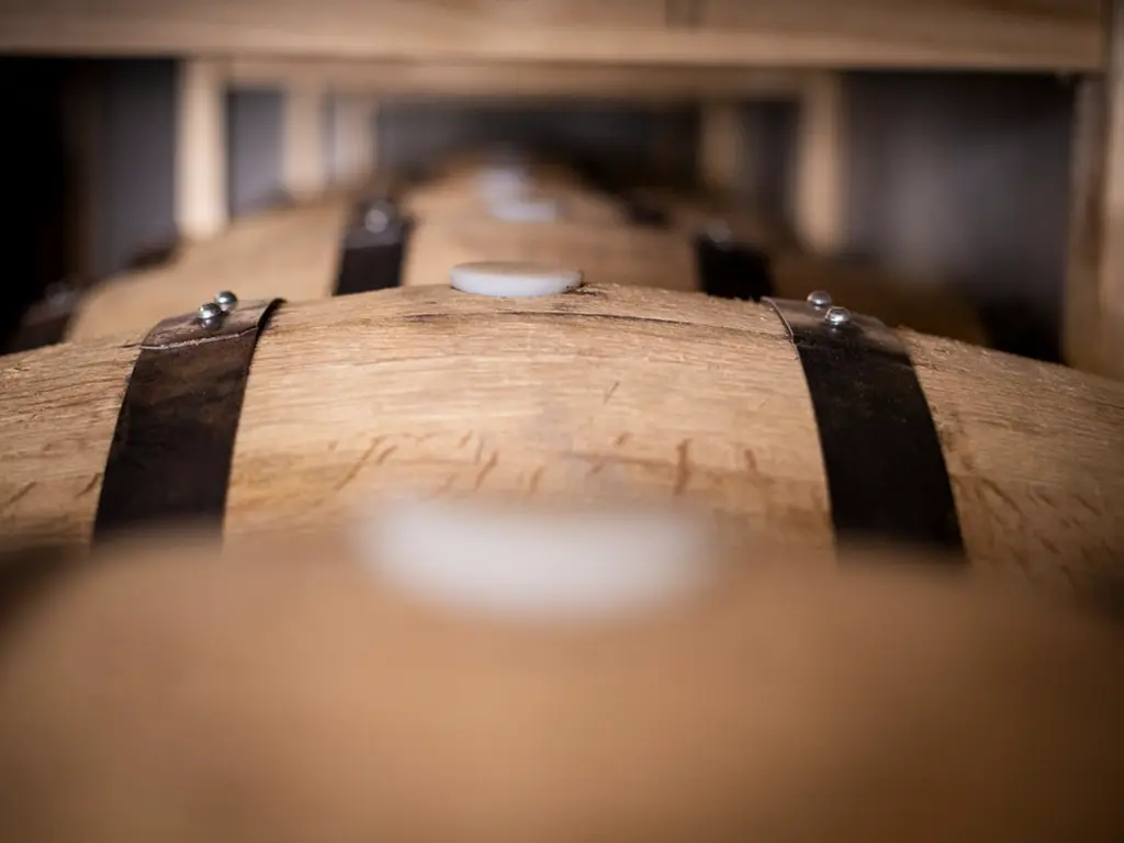 barrels of whisky aging at the white label distillery in tasmania
