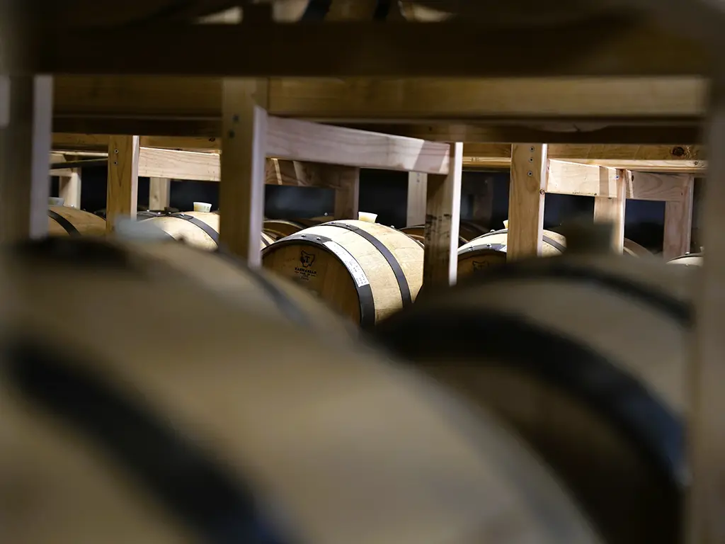 barrels of whisky maturing at the white label distillery in tasmania